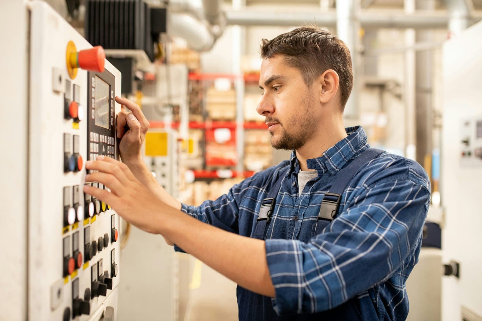 A field service technician working on industrial equipment during an on-site mission