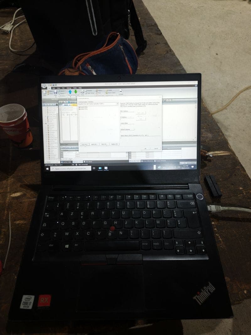 A technician diagnosing an industrial control fault remotely from a laptop